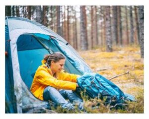 Getting out of her camping tent