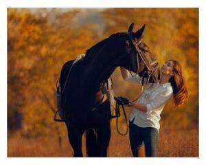 Woman petting her horse