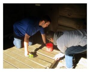 Volunteers repairing deck boards